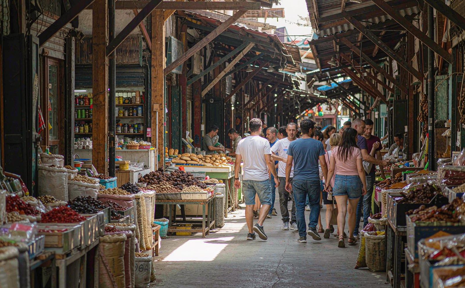 Travellers eating together at a busy Turkish street food market, grilled meat and flatbread