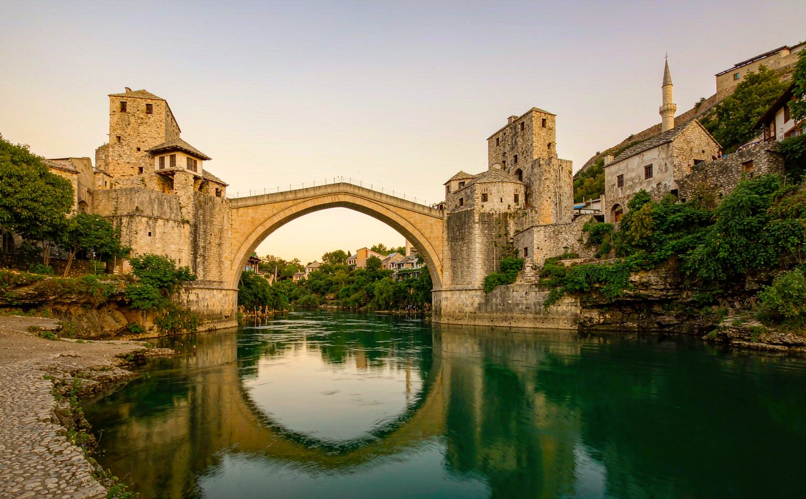 Stari Most, the single-arch Ottoman stone bridge in Mostar, reflected in the Neretva river