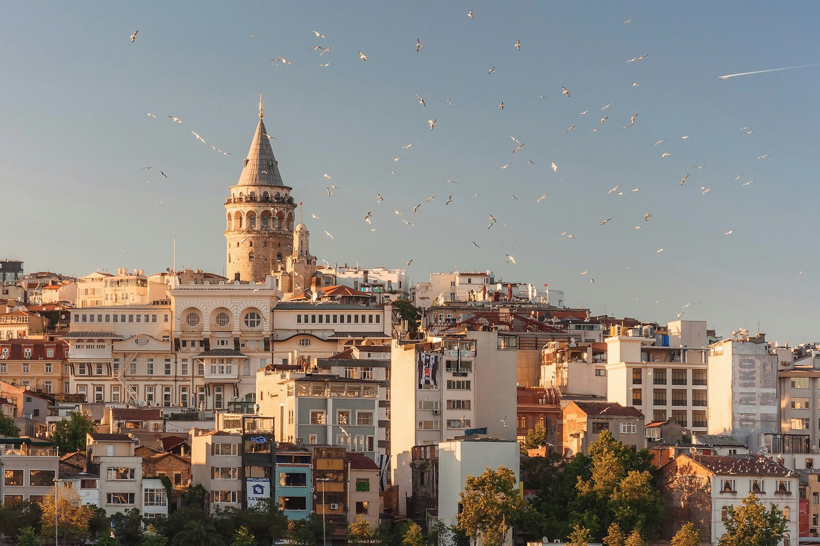 Hot air balloons drifting over the fairy chimneys of Cappadocia at sunrise