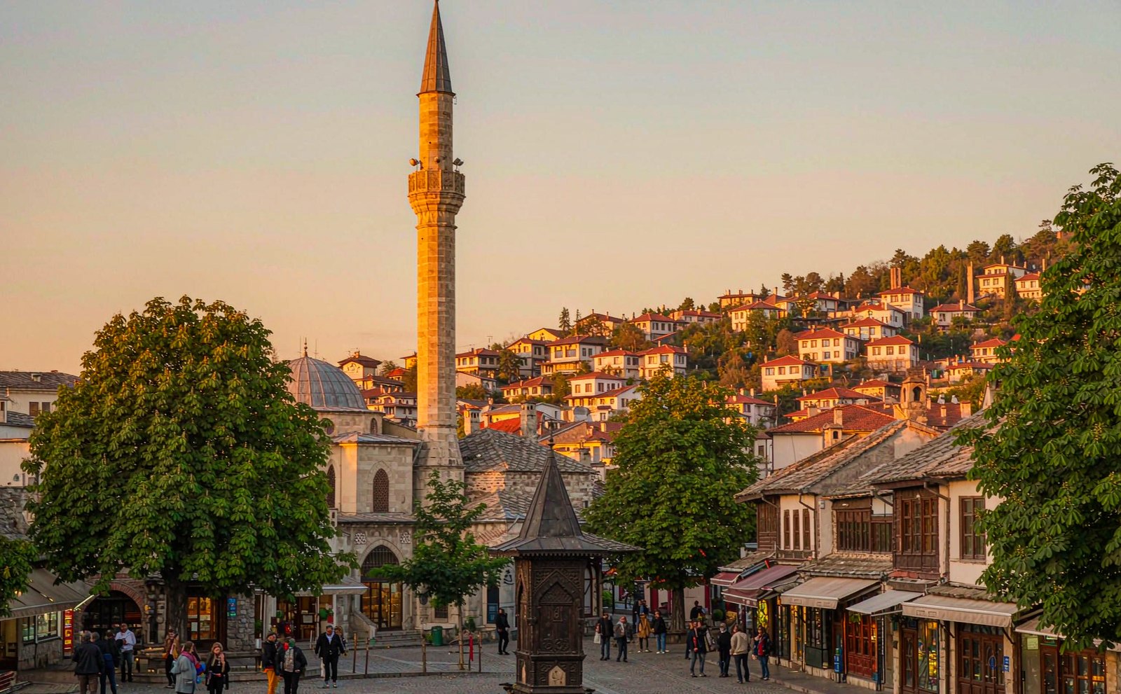 Sarajevo's old town at golden hour, with the Gazi Husrev-beg mosque minaret and hillside houses